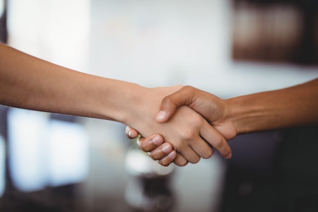 Hands of business people shaking hands in office